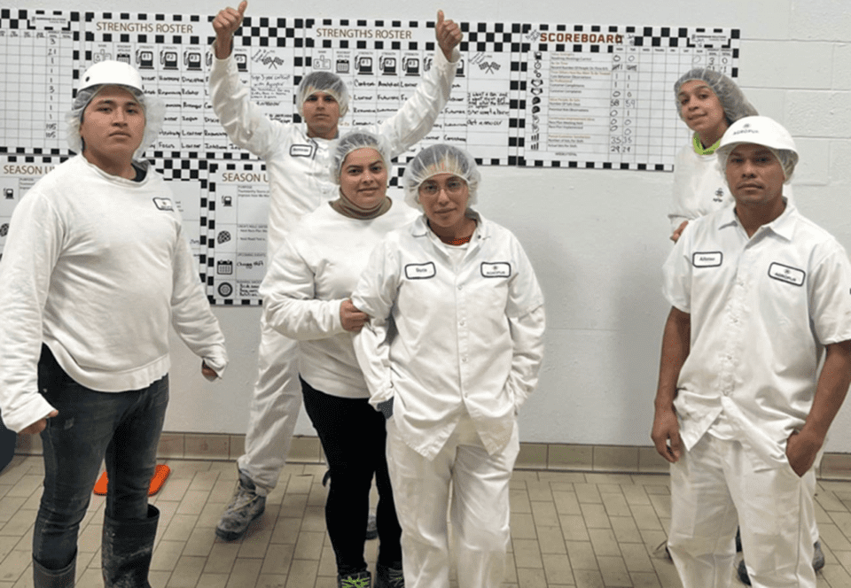 Sanitation crew smiling for a picture with their thumbs up
