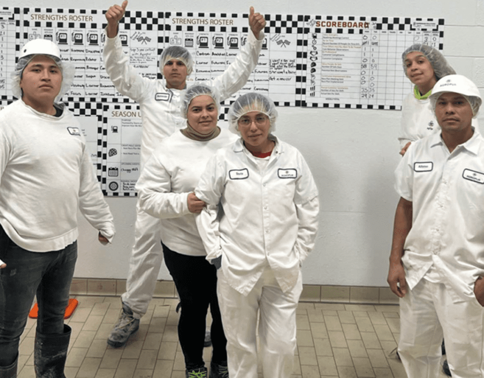 Sanitation crew smiling for a picture with their thumbs up